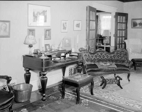 J.G. Fuller House, 215 Lathrop Street. The living room features an antique desk and sofa.