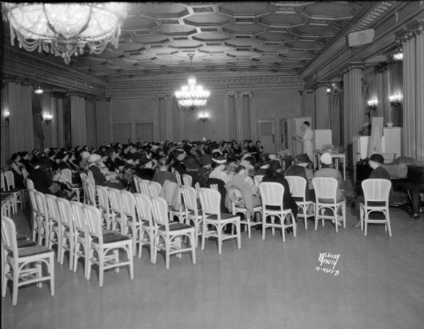 Woman lecturing to a large group of women at the Kelvinator School, in the Loraine Hotel.