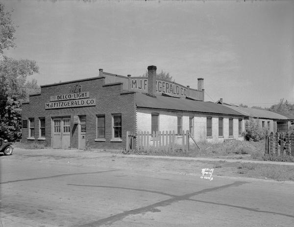 Exterior view of the M.J. Fitzerald Co., lighting plant parts, 306 East Wilson Street. "Parts for Delco-Light."