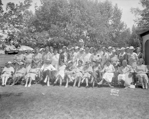 Group portrait, taken outdoors at Nakoma Country Club, of hostesses for the Wisconsin Women's Golf Association tournament.