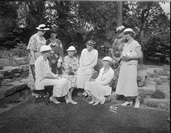 Past Presidents of the Woman's Club posing outdoors of the H.L. French home, 500 Farwell Drive, Maple Bluff. Mrs. Jenks, Mrs. Richards, Mrs. Ritter, Mrs. Lamb, Mrs. Thwaites, Mrs. Ramsay, Mrs. Buell, Mrs. Barnes.