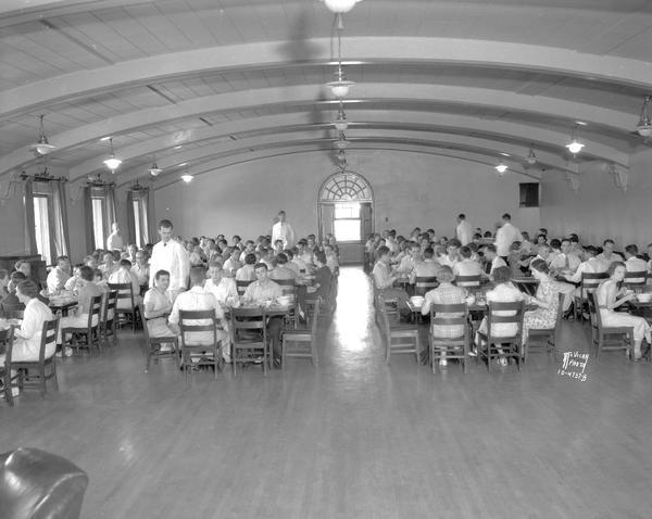 Men and women eating in Upper Dining Room, University of Wisconsin-Madison Van Hise Men's Refectory, 1220 Linden Drive.