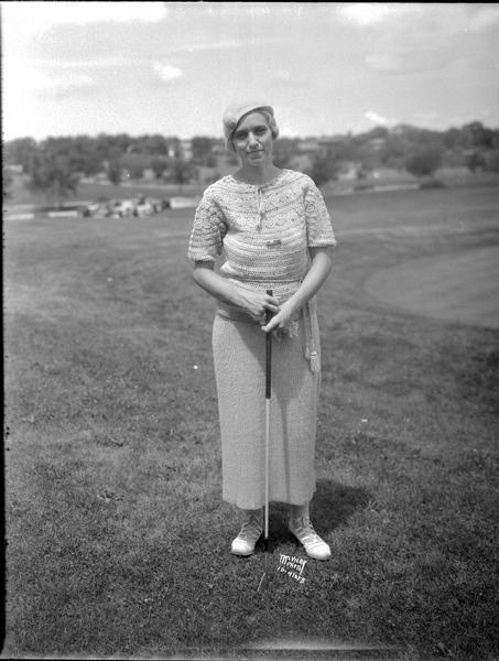 Outdoor portrait of Mrs Karl Luetke, Green Lake, Wisconsin, finalist in Women's State Golf Championship.