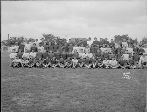 Outdoor group portrait of the East High School football team.