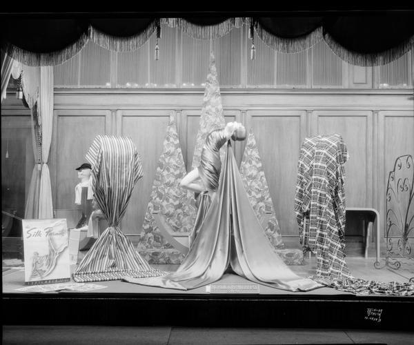 Burdick & Murray Co. "Silk Parade" window display featuring silk fabrics, and two window mannequins draped with fabric. 15-17-19 E. Main Street.