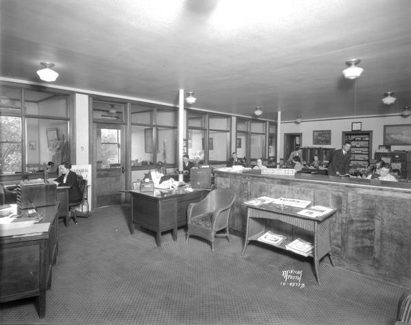 People working in the office of Reitan Lerdahl Co., Room 300-312, Pioneer Building, 105 Monona Avenue. (Martin Luther King Jr. Boulevard.)