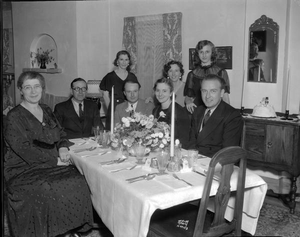 Eight people enjoying a wedding supper in the home of Dr. John Hill, 514 South Park Street, for newlyweds (?) James H. Hill Jr. of Baraboo, and Kathryn Born of Oklahoma.