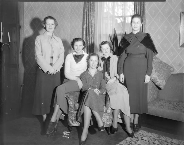 Group portrait of five best dressed co-eds at the University of Wisconsin, picked in a poll conducted by the Daily Cardinal. All are sorority women.
