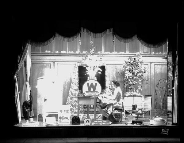 Westinghouse Electric Supply Co., 1022 East Washington Avenue, window display featuring Westinghouse appliances and a female model using a mangle.