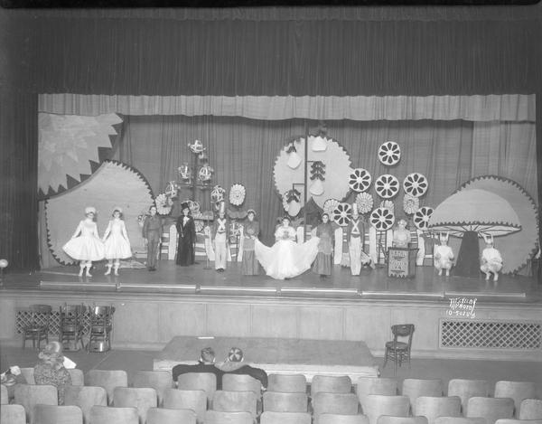 Students on stage in costume at East Junior High School in a scene from a Christmas play.