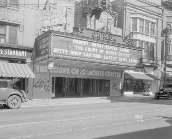 Orpheum Theatre, 216 State Street marquee showing "Robert Donat & Elissa Land - Count of Monte Cristo - Betty Boop cartoon - latest news events"  Other businesses shown: Weber's Restaurant, (218), Tom McAn Shoestore, (214), Spanish Tavern Cafe, (212).