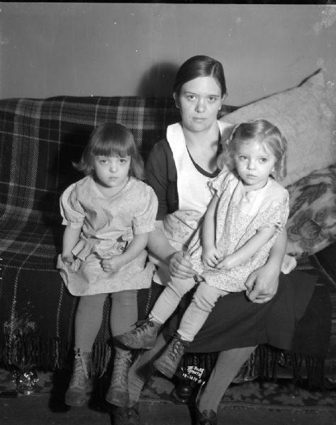 Mrs. Robert Nadig and daughters, Joane and Betty Jane, after they escaped from a fire at 917 Clarence Court.