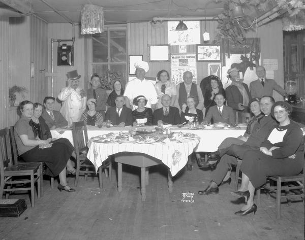 Group portrait of 21 people, (play cast), some in costume, at Art Knisley's supper party at a tavern on Middleton Road. Handwritten on negative sleeve: "Art Knisely, Ad Manager, Burdick & Murray, lived in Middleton."