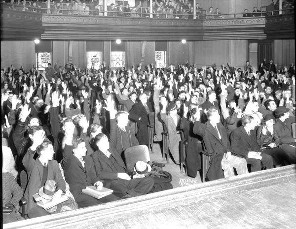 Group portrait of "one thousand" University of Wisconsin-Madison students, enlisted in the war against war at a peace mass meeting and anti-war strike, voting on a four-point peace program in Music Hall.