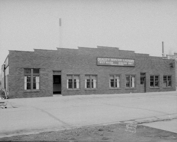 Quality Laundry Service building at 10 N. Charter Street. Sign reads: "Wet Wash, Rough Dry."