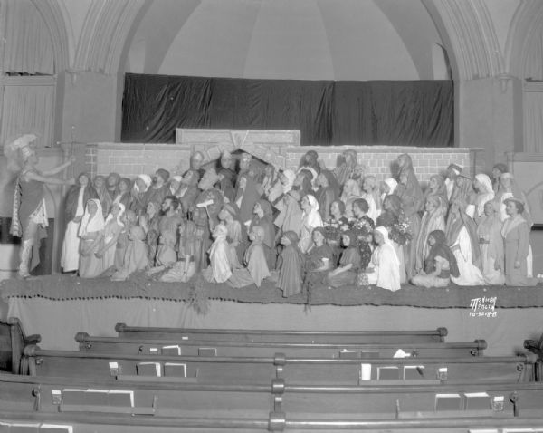 First Methodist Church, 203 Wisconsin Avenue. Easter pageant "At Dawning," with a large group of actors in costume in a scene on "stage" in the chancel.