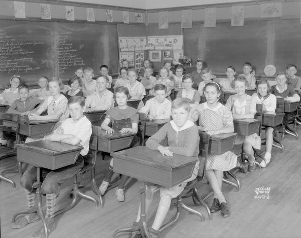 Sixth grade students sitting at desks in the sixth grade classroom at Dudgeon School, 3200 Monroe Street.