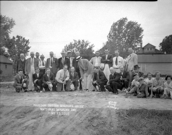 At ceremonies held in observance of National Housing Day, Mayor James R. Law and members of the Madison Building Industries Committee are shown breaking ground for a model home on "South Shore Drive" now called 822 West Shore Drive.