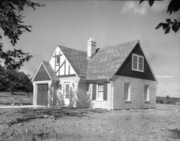 Eldon Everett house, 425 Toepfer Street. Westmorland. Brick-half timbered above entry, garage on left of entrance.