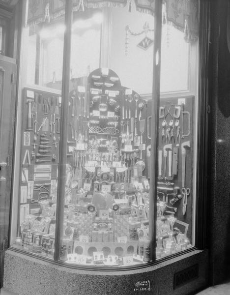 F.W. Woolworth Co. hardware display window showing tools and kitchen utensils.