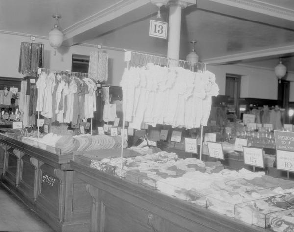 F.W. Woolworth Co., 1 E. Main Street, interior showing counter displays and clothing racks.
