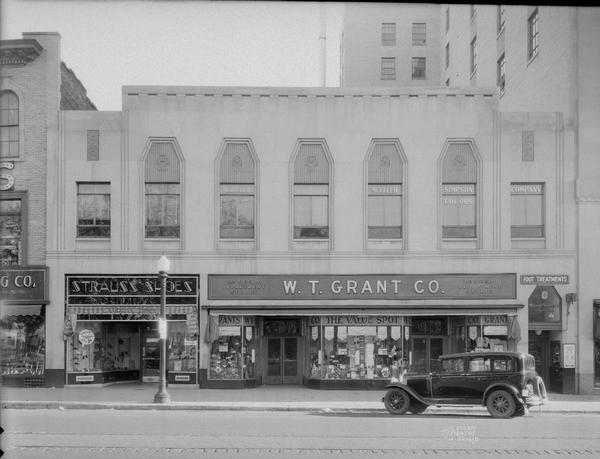 View of South Pinckney Street. From right to left: W.T. Grant Co., variety store, 21-23 S. Pinckney Street, and Strauss Shoes, 19 S. Pinckney Street, on the ground floor of Madison Merchants Realty Co. Building with Mueller-Simpson Co. merchant tailors upstairs.