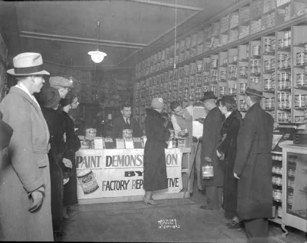 Men and women watching a Mautz Paint Co., demonstration in store at 118 State Street.