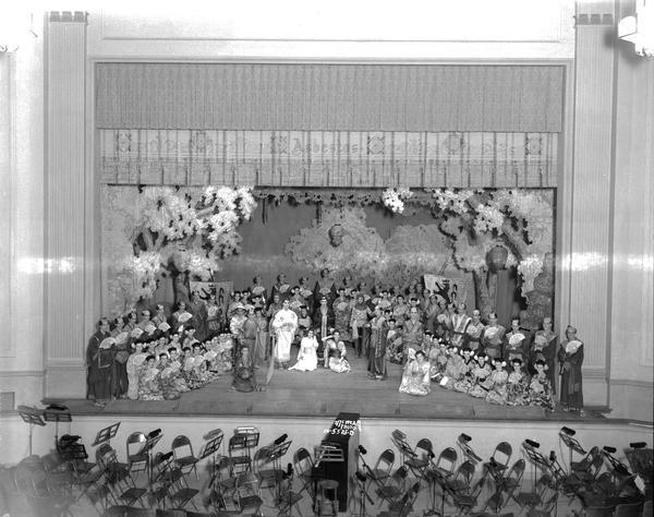 Elevated view of the entire cast of the "Mikado" operetta on stage at West High School.