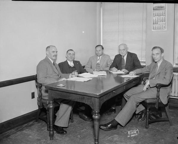 Administration of Wisconsin's unemployment insurance law is in the hands of l to r: Harry Lippart, director of employment service; Industrial Commissioners Harry McLogan, Peter Napiecinski, Voyta Wrabetz, and Director Paul A. Raushenbush, director of the Unemployment Compensation Department of the Wisconsin Industrial Commission.