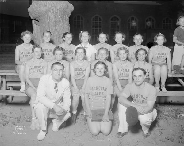 Group portrait of Recreation Dept. Women's Championship Softball Team sponsored by Lincoln Life Insurance Co. Fifteen women in uniform and two men.