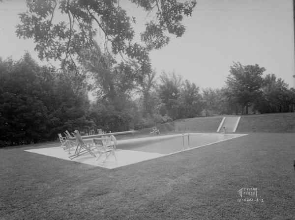 Dr. Frederick Davis residence, 6048 S. Highlands Avenue, called Edenfred, with a swimming pool with two people and a dog.