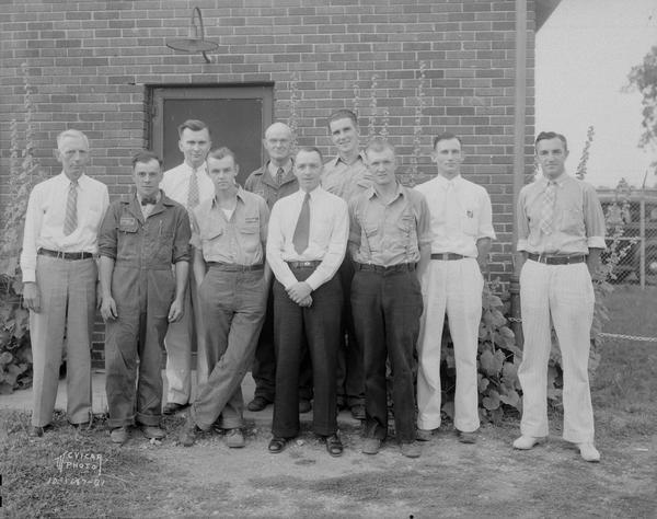 Outdoor group portrait of ten male employees of Philgas Co.