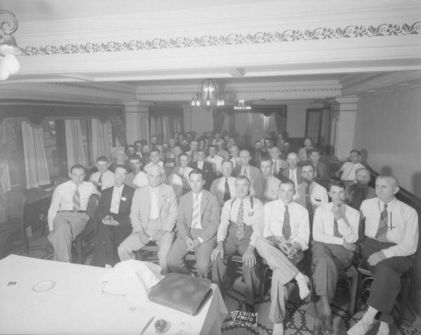 Group portrait of Woodman's Casualty Insurance salesmen's meeting in the Venetian Room of the Loraine Hotel, 119-125 W. Washington Avenue.