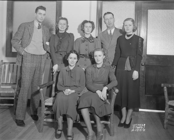 Group portrait of University of Wisconsin Court of Honor girls for the President's Birthday Ball, with Roundy Coughlin and another man.