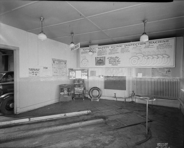 Safety clinic section, Eichman Garage, 1307-09 Williamson Street, "National Safety Inspection Machine, brakes, steering and lights, triple checked for safety."