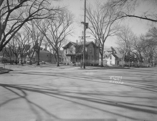 Houses and neighborhood, corner of W. Gorham and N. Carroll Street looking south and west. Shows houses at 312 N. Carroll and 324 N. Carroll and 107 W. Gorham Streets. Site of Gay Brothers Lyon Apartment Building.