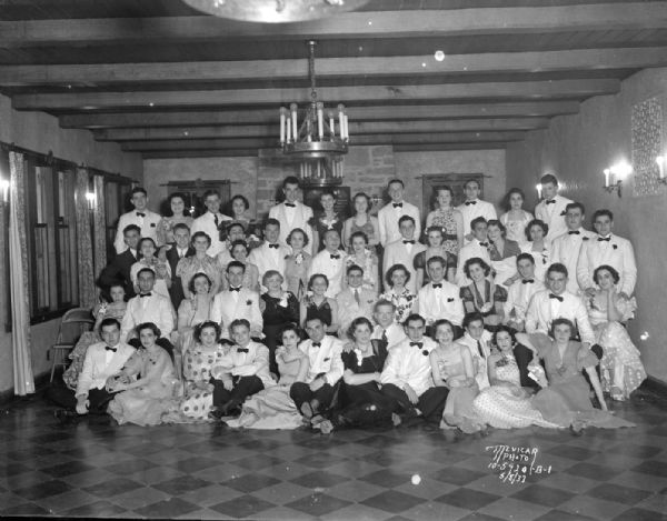 Group portrait of men and women at a Phi Sigma Sigma Sorority Spring formal at Nakoma Country Club.