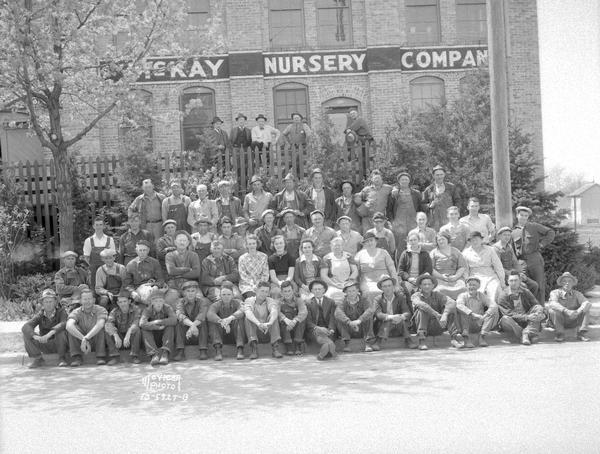 Group portrait of employees in front of the McKay Nursery Co. building.