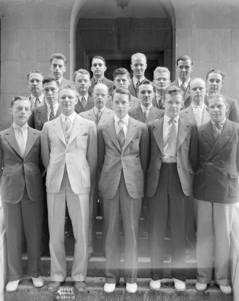 Group portrait of men in the Memorial Union Dormitories and Commons Committee on the steps of the Memorial Union, University of Wisconsin.