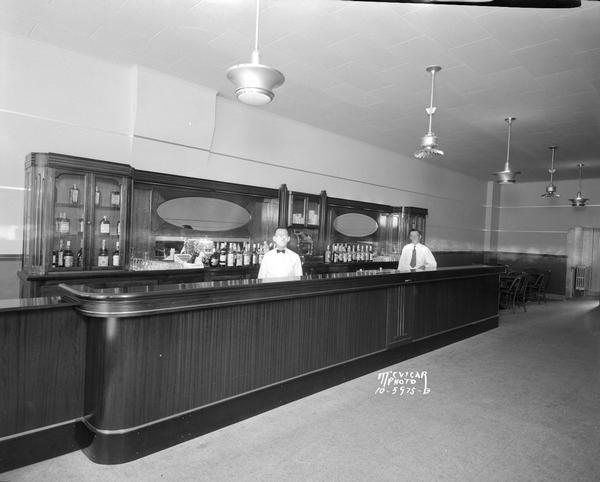 Interior of Club Royal, 122 East Washington Avenue, with 2 bartenders standing behind the bar.