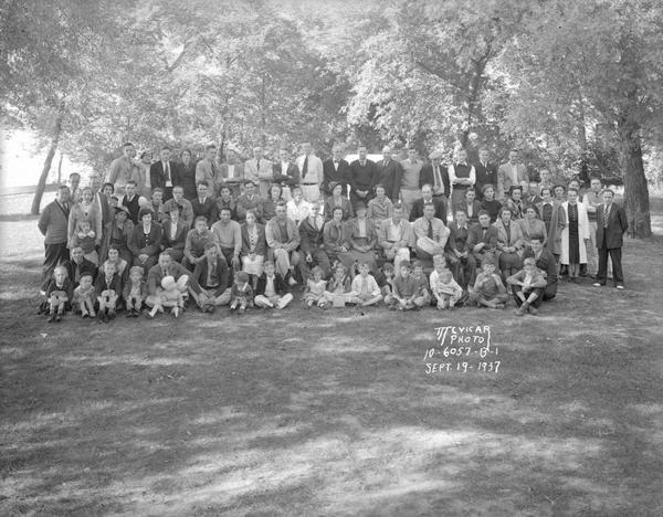 Group portrait of Kayser Motors employees and their families on a picnic at Burrows Park.