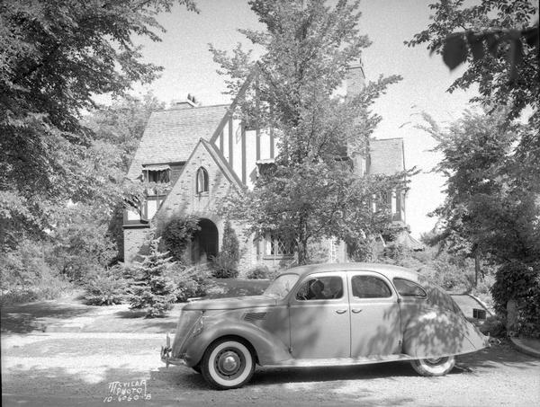 Zephyr automobile, with couple sitting in the front seat, parked in front of Russell and Louise Carpenter home, 50 Cambridge Road, taken for Kayser Motors.