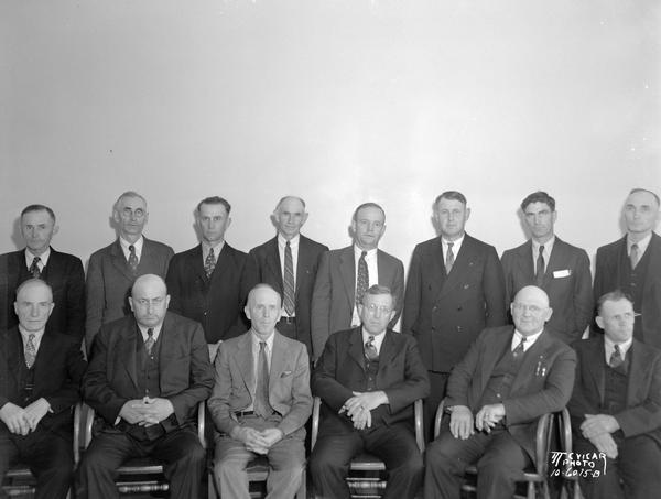 Group portrait of 14 men chosen for the jury in a federal petrolium industry trial. On trial were 22 oil companies, 46 individuals, and three publications for conspiring to artificially raise and fix gasoline prices throughout the Midwest, violating the Sherman Anti-Trust Act.  Case led Wisconsin Legislature to adopt the Unfair Sales Act in 1939.