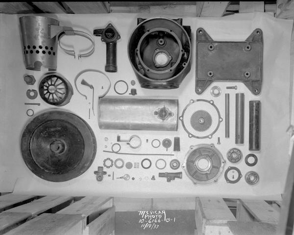 Display of metal replacement parts for farm light plants, taken for M.J. Fitzgerald Co. 2034 Jenifer Street. Photograph to be used in a catalog.