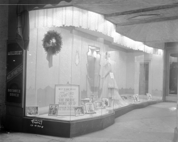 Woldenberg's, 26 E. Mifflin Street, "Joan Crawford" window taken for the Orpheum Theatre. "One of the many dresses worn by Joan Crawford in the picture: 'The Bride Wore Red.'"