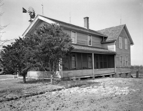 Farmhouse near McFarland before remodeling, with a windmill behind the house on the left.