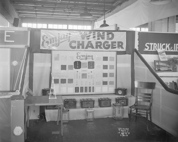 Emjay Wind Charger booth at the ESBMA (East Side Business Men's Association) Fall Festival, featuring batteries and charger parts. Taken for M.J. Fitzgerald Co., 2034 Jenifer Street.