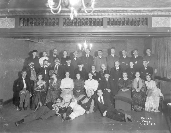 Group portrait of University of Wisconsin Spanish Department play cast in costumes on stage at Bascom Hall.
