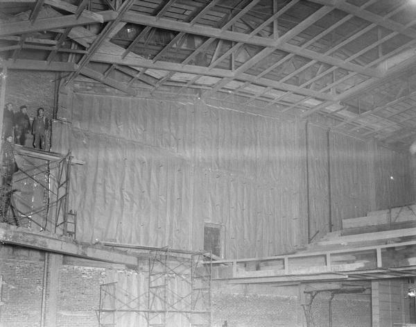 University of Wisconsin Memorial Union Theatre under construction, showing interior with four men on scaffolding.