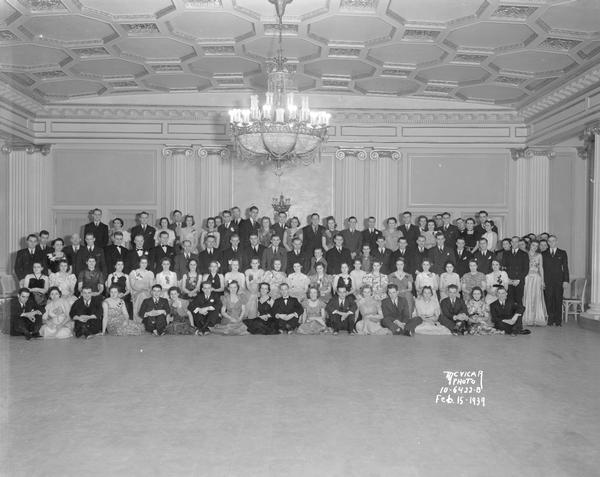Group portrait of Madison College party group in Crystal Ballroom, Loraine Hotel.